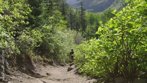 Establishing Shot, wide reveal of Native American man hiking in mountain forest