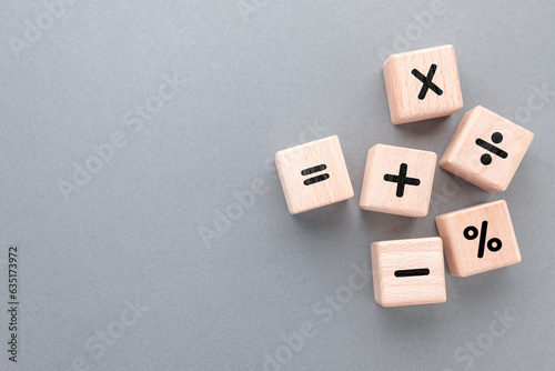 Mathematics operation signs by wood cubes, learning mathematics, and calculation concept