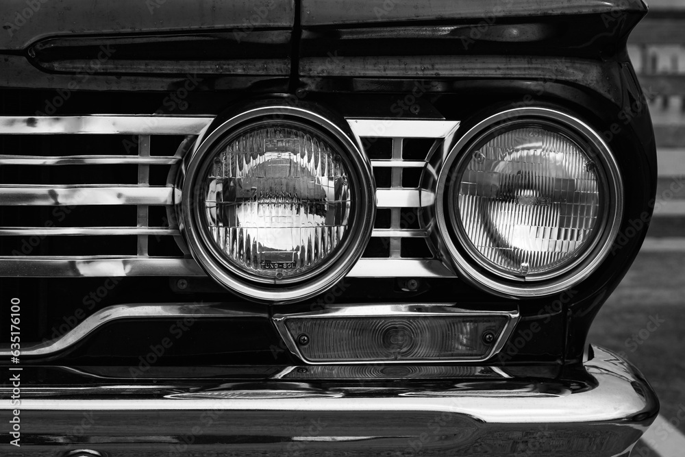 Classic car headlights close-up. Headlights of black vintage car