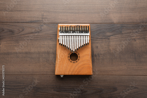 Wooden kalimba on the wooden background. Overhead photo of mbira instrument with copy space.