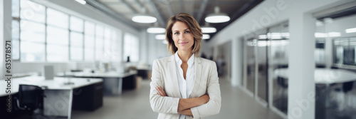 Free Download Portrait of a middle-aged business woman in a bright modern office - GFXLoad