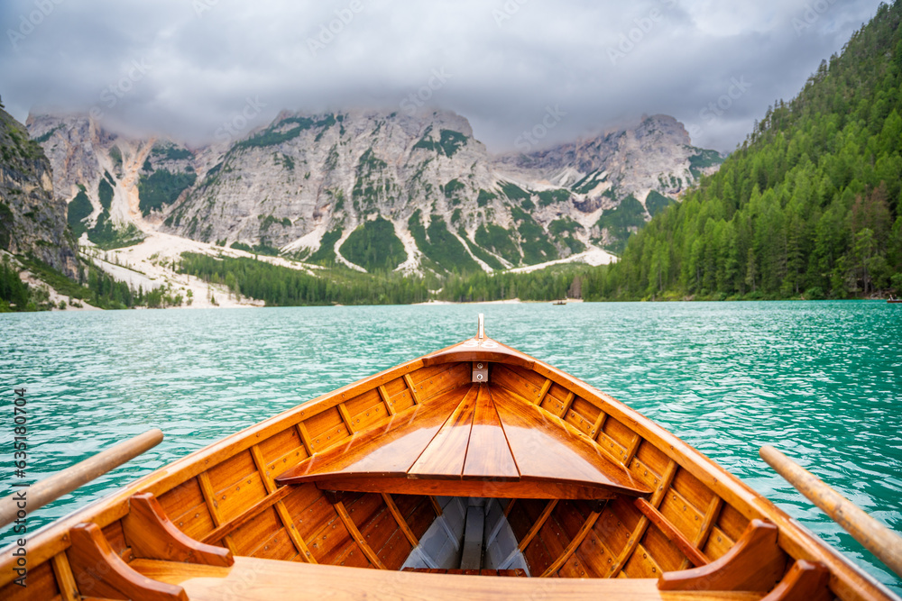 Traditional wooden rowing boat on scenic Lago di Braies in the Dolomites, South Tyrol, Italy