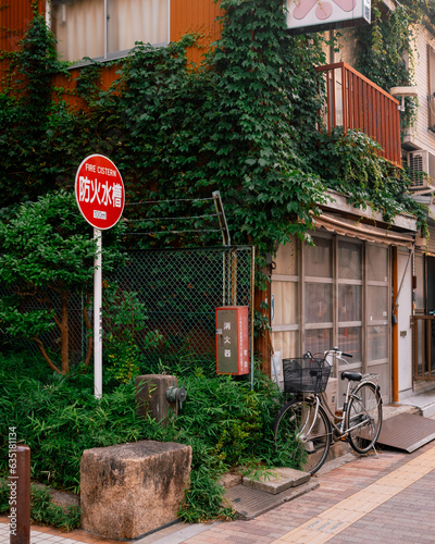 bicycle in front of a building next to a stop sign © Ryan Bates