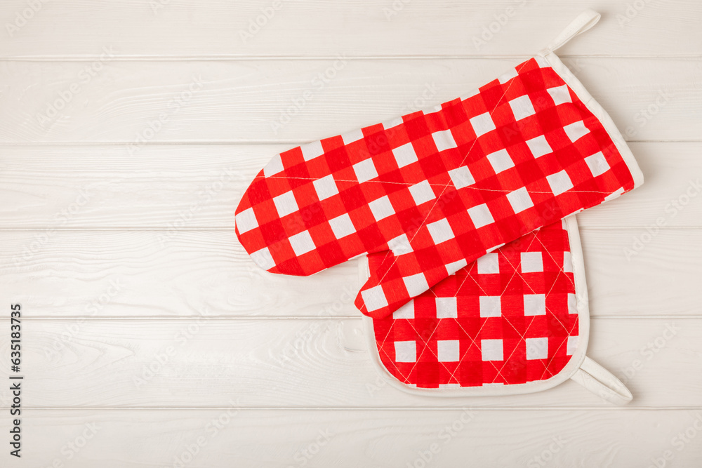 Fototapeta premium Wooden kitchen utensils, cutting board, potholder and glove on the table, top view. Kitchen Mitten and protective oven mitts on the table. Kitchenware. Kitchen accessories.Close-up.top view.