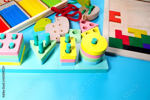 Colorful kids toys frame on wooden background Wooden educational toys Educational toys Montessori sensorial activity for toddlers baby Hands eyes coordination Intelligence game Place for your text