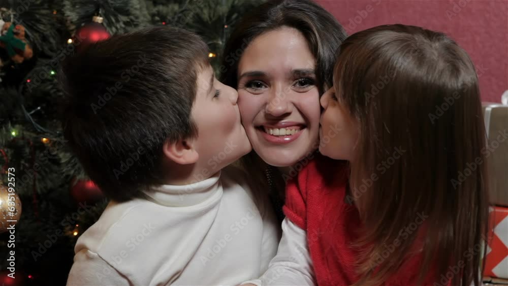 Attractive brunette woman with young kids smiling for the camera Attractive brunette woman with young kids smiling for the camera
