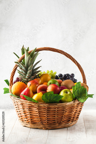 Fototapeta Naklejka Na Ścianę i Meble -  Basket with ripe exotic fruits. Harvesting.