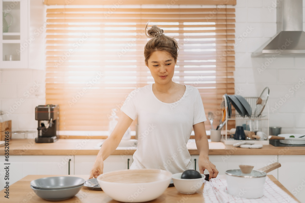 Portrait of happy asian woman preparing breakfast in the kitchen in the morning. Portrait of happy asian woman preparing breakfast in the kitchen in the morning.