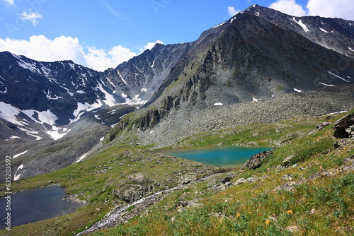 Mountain summer landscape, Altai. Colorful lake in the gorge. Summer hiking in the mountains.