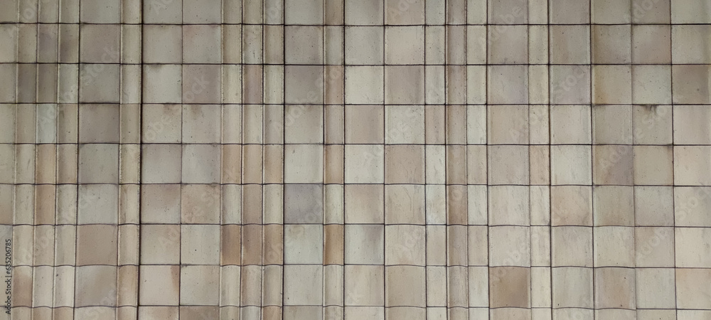 Abstract textured wall background. Old weathered beige ceramic tiled wall. Copy space for your text or decoration. Abstract textured wall background. Old weathered beige ceramic tiled wall. Copy space for your text or decoration.