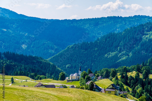 A view towards the alpine village of Kranjska above lake Bohinj in Slovenia in summertime 