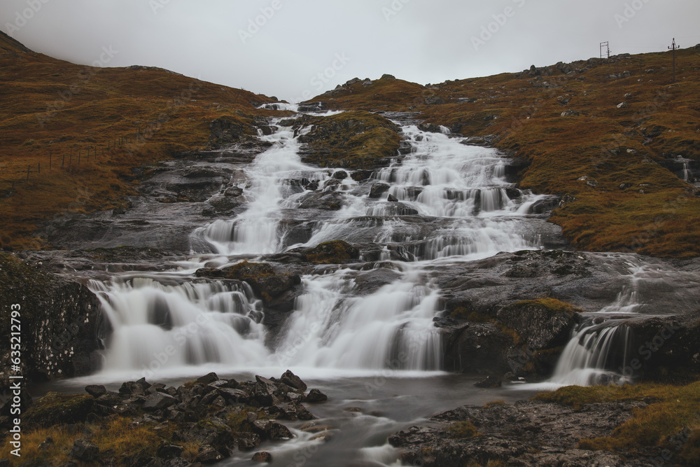 beautiful waterfall in the mountains of Faroe islands beautiful waterfall in the mountains of Faroe islands