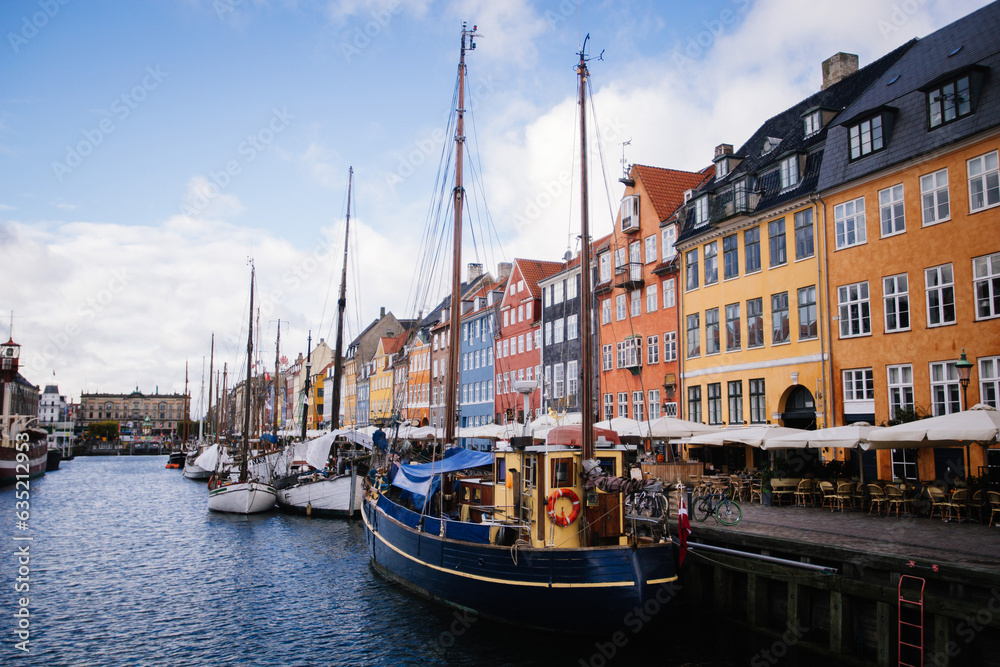 Beautiful canal full of boats and colorful buildings in the background Copenhagen Denmark