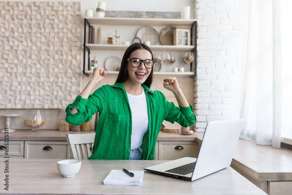 Portrait of a young business woman, a freelancer who rejoices at the finished successful project, looks at the camera and rejoices at the success. Portrait of a young business woman, a freelancer who rejoices at the finished successful project, looks at the camera and rejoices at the success.