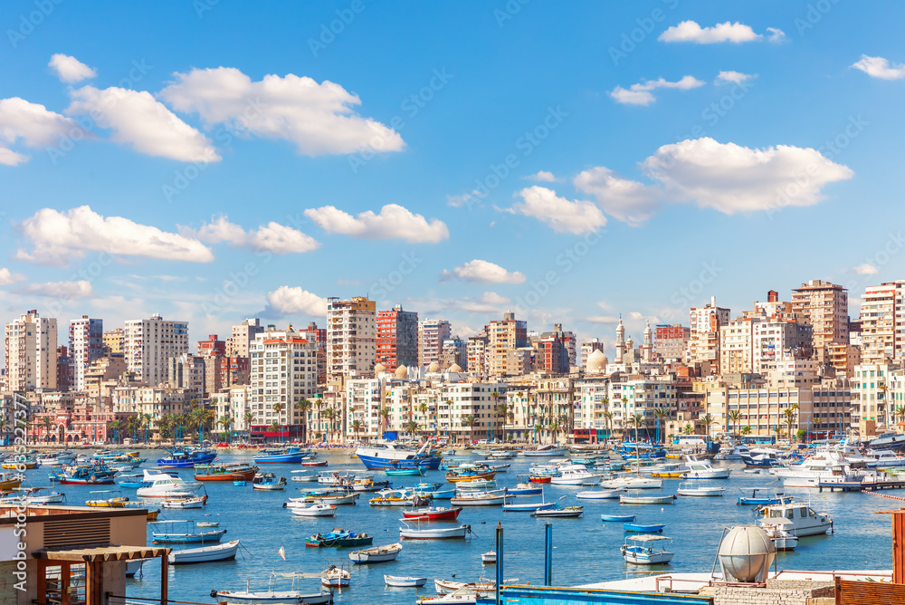 Boats near the pier and view of Alexandria coast, Egypt