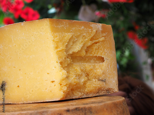 Obraz na płótnie Cheese, a large piece lying on a wooden board, close-up. Natural products, the concept of healthy nutrition. w salonie