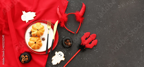 Stylish Halloween table setting with pumpkin buns on dark background with space for text