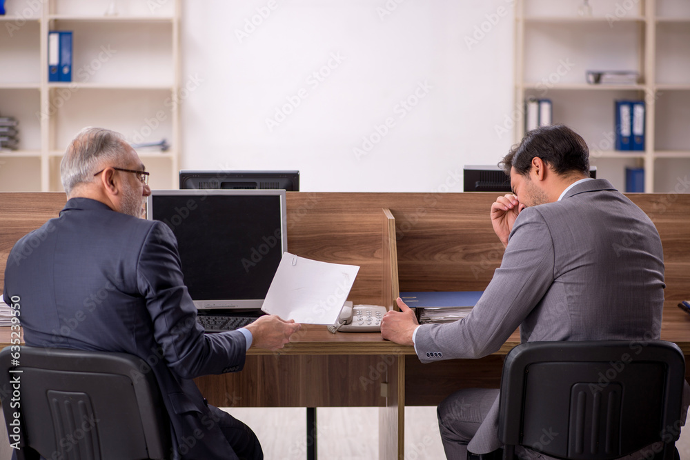 Two male colleagues working in the office Two male colleagues working in the office