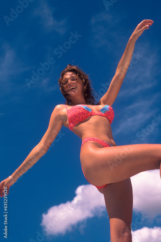 Low angle view of a woman in a bikini