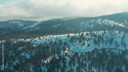 Drone flight over the snowy mountains of Troodos
