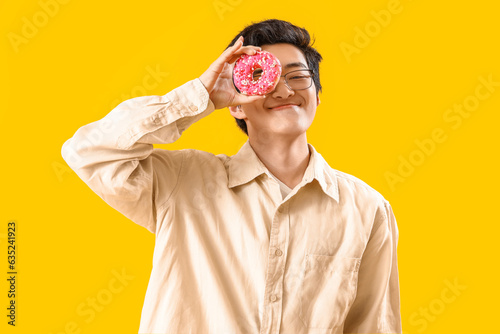 Young Asian man with tasty ...