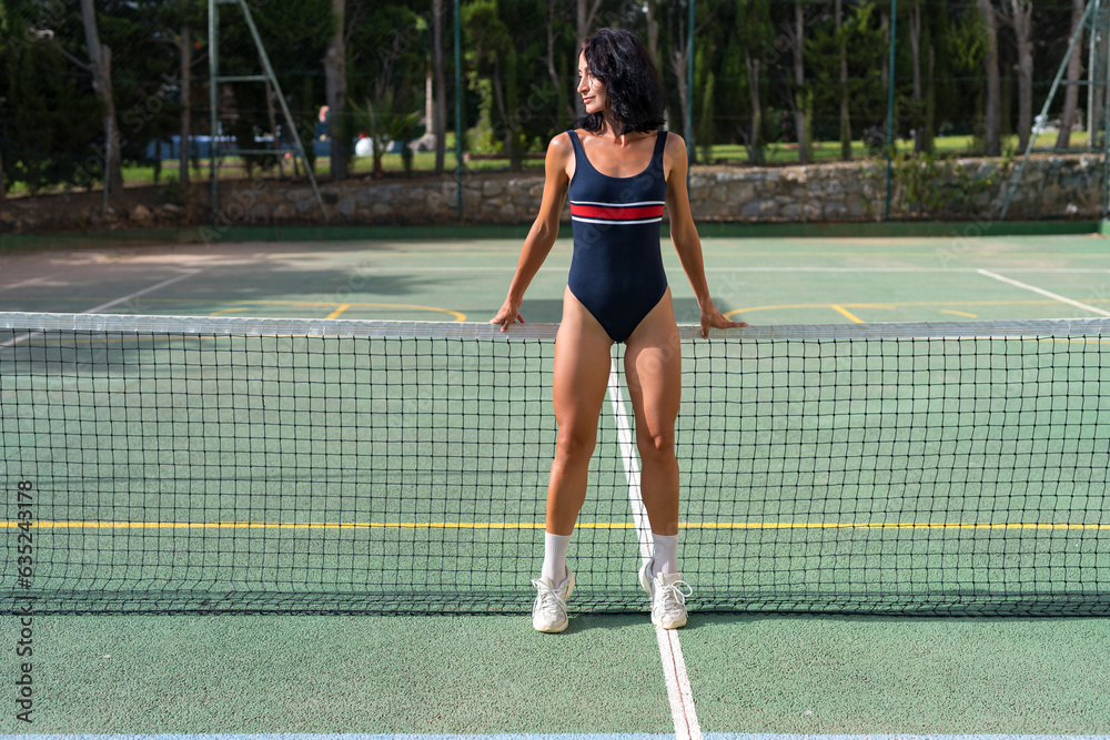 girl tennis player on the tennis court with a racket in her hands