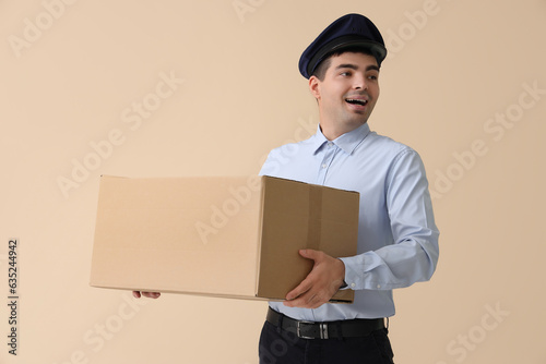 Young postman with parcel o...
