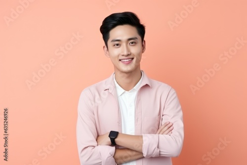 Portrait of a fictional elegant handsome Chinese man in a pink suit. Isolated on a plain colored background. Generative AI.