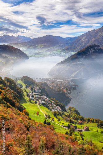 Fabulous autumn view of Stansstad city and Lucerne lake with mountaines and fog.