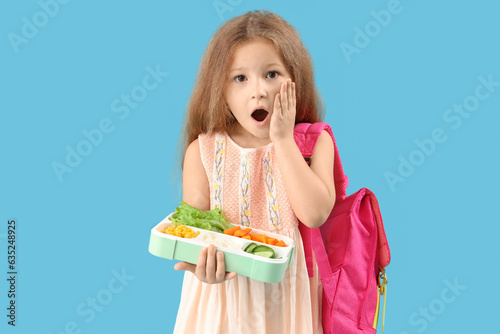 Shocked little girl with ba...