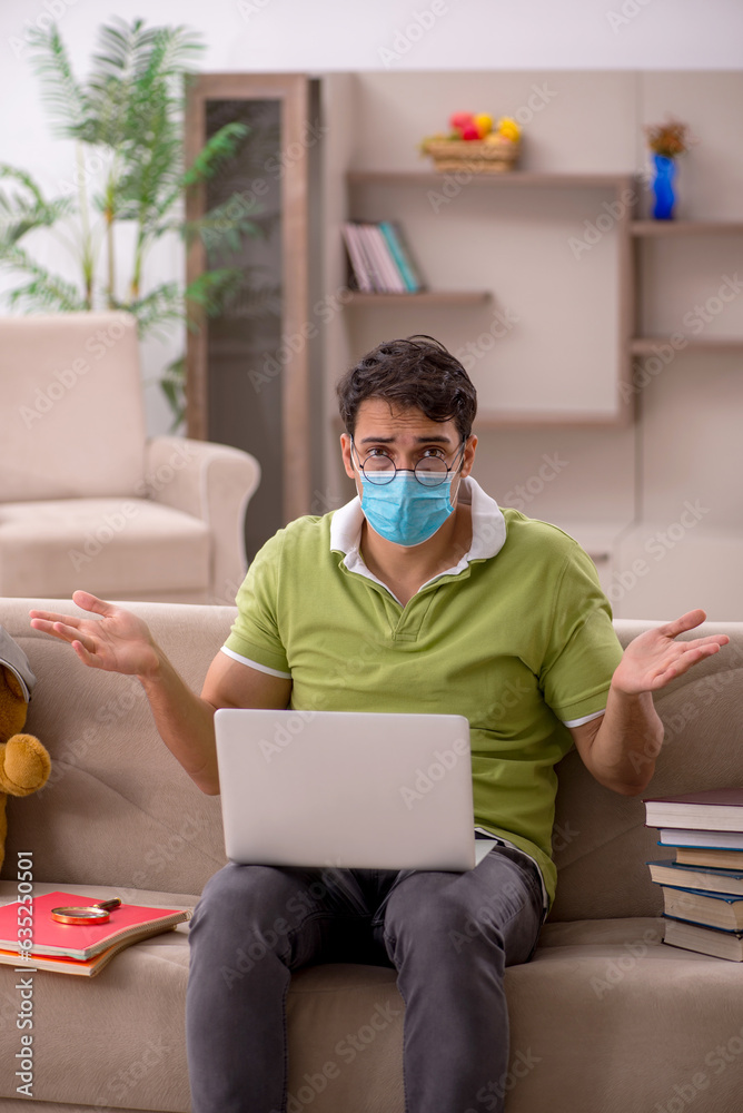 Young male student preparing for exams at home during pandemic Young male student preparing for exams at home during pandemic