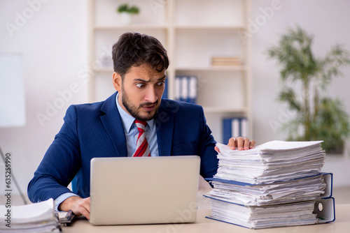 Young male employee working in the office