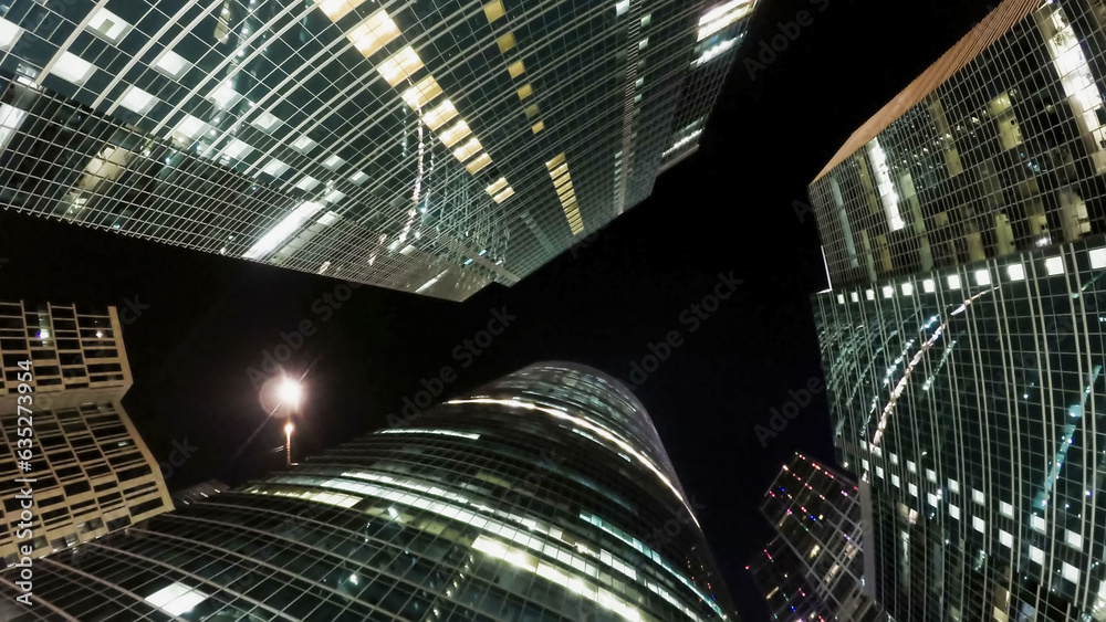 Group of modern skyscrapers in night business city at night. Abstract modern background