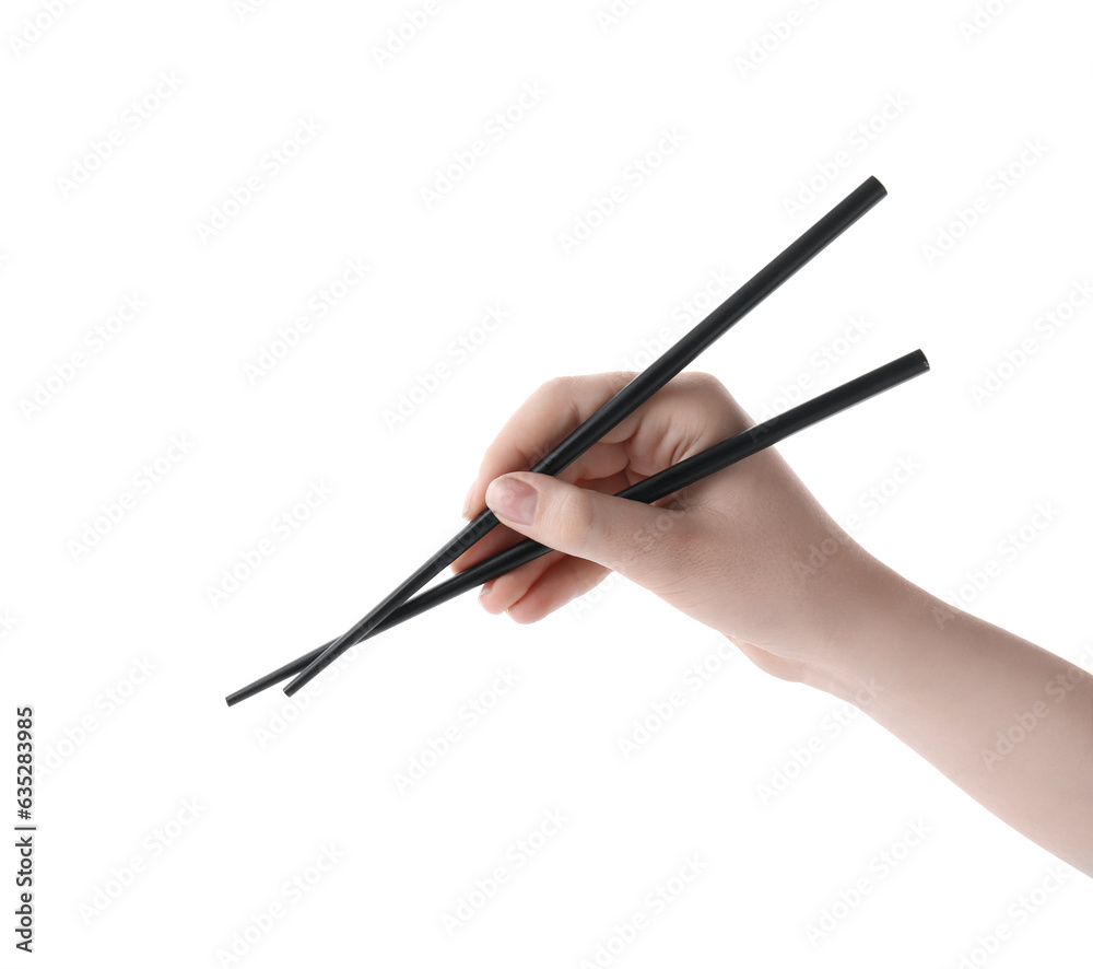 Woman holding pair of black chopsticks on white background, closeup Woman holding pair of black chopsticks on white background, closeup