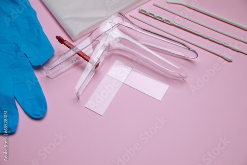 Sterile gynecological examination kit on pink background. Space for text photo