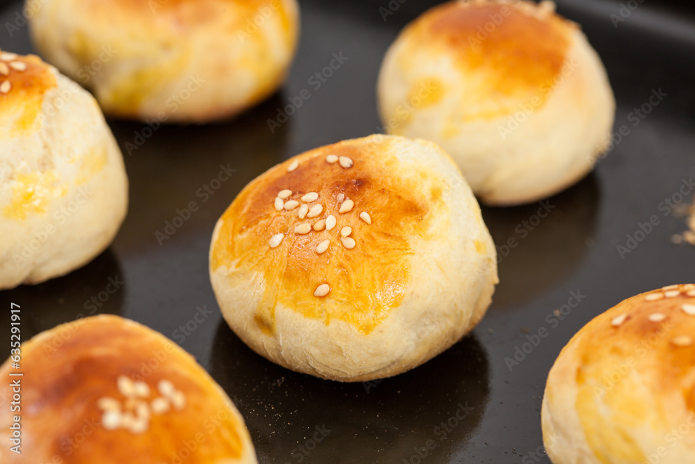Just baked small bread buns for mini burgers. Step by step preparation of mini burgers. Homemade mini burgers for children or appetizers. Small hamburgers.