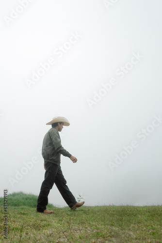 Misty Adventure - Man Walking through Mexican Hat Landscape