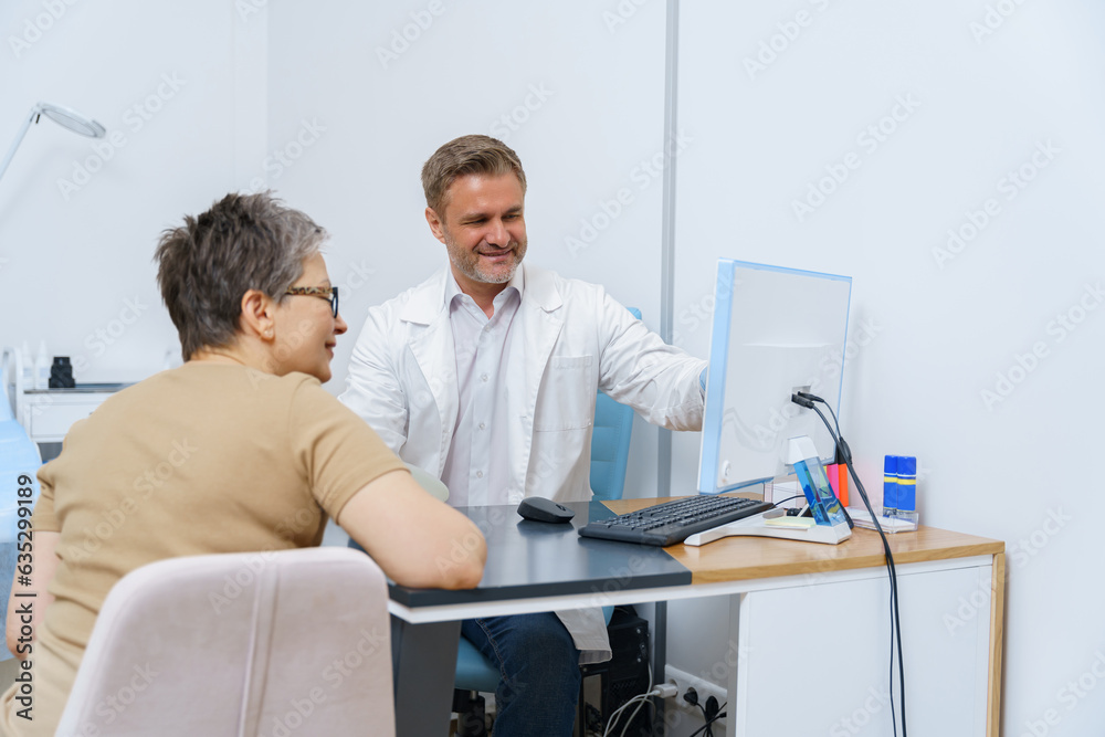 Doctor consulting a female patient during appointment in modern clinic. High quality photo Doctor consulting a female patient during appointment in modern clinic. High quality photo