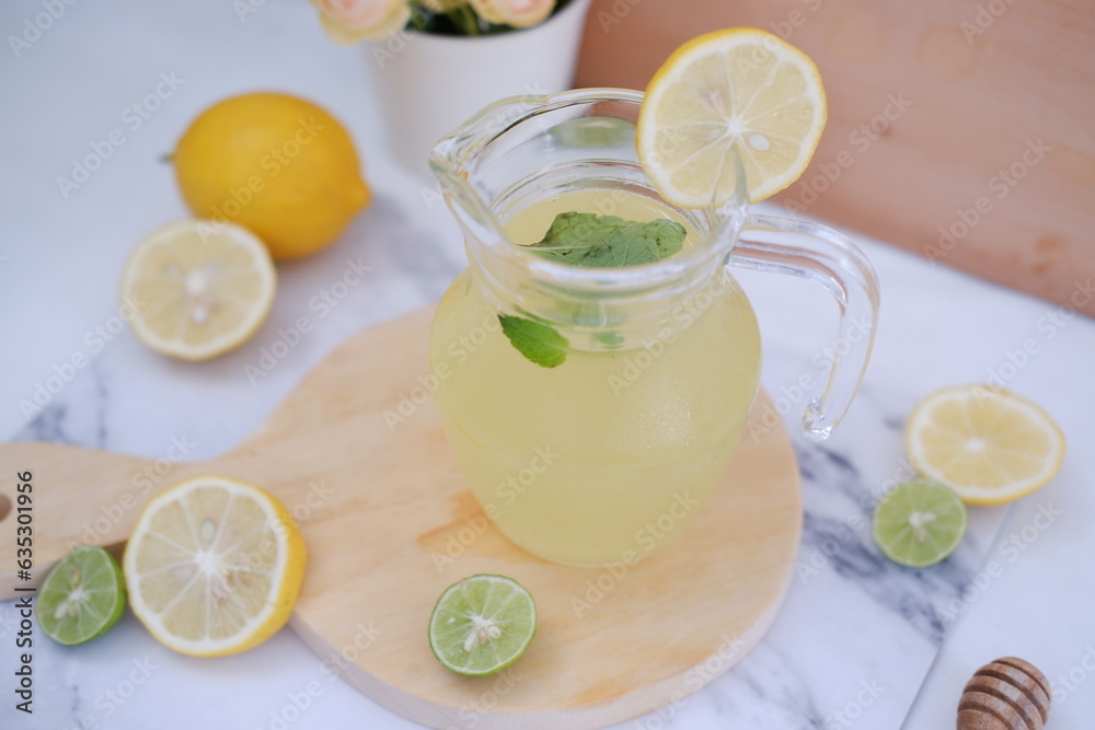 Lemonade with fresh lemon and mint leaves on a white background Lemonade with fresh lemon and mint leaves on a white background