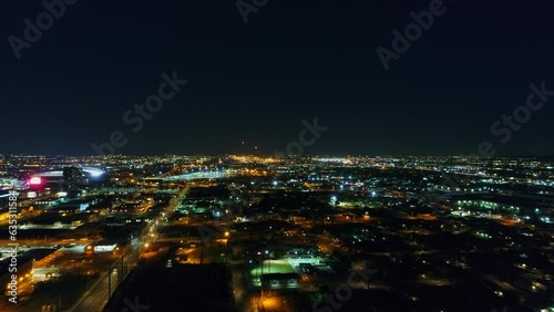 Aerial Forward Shot Of Illuminated Cityscape Against Sky At Night, Drone Flying Forward Over Buildings - Phoenix, Arizona photo