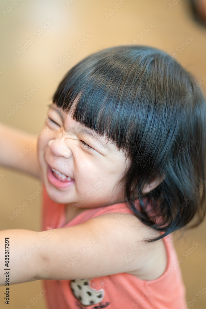 Portrait photo of white little girl with black hair is wearing orange suit in cutety action. People portrait photo with facing focus. Portrait photo of white little girl with black hair is wearing orange suit in cutety action. People portrait photo with facing focus.