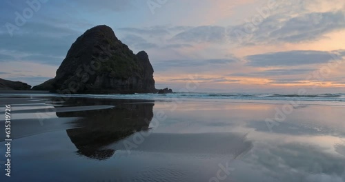 Aerial: Calm rocky coastline at sunset. Auckland, New Zealand