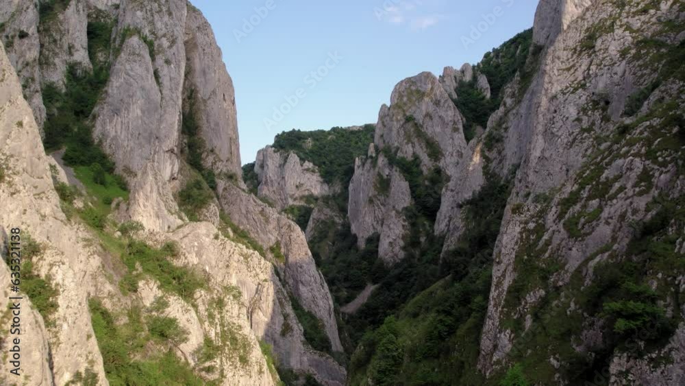 view from between cliff mountain ranges during sunset light, flying between rocks view from between cliff mountain ranges during sunset light, flying between rocks