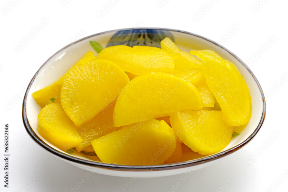 Sweet and tart slices of yellow pickled daikon, known as takuan in Japan and danmuji in Korea. Sweet and tart slices of yellow pickled daikon, known as takuan in Japan and danmuji in Korea.