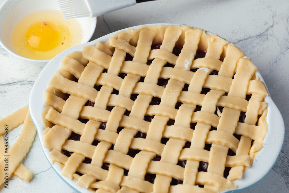 Delicious uncooked homemade cherry pie with Flaky Crust. American traditional pastry. Flat lay. Raw summer berry tart dessert sprinkled with sugar Delicious uncooked homemade cherry pie with Flaky Crust. American traditional pastry. Flat lay. Raw summer berry tart dessert sprinkled with sugar