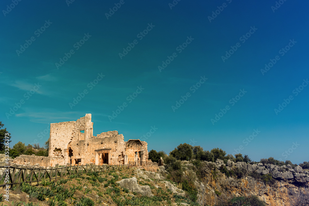 Canytellis, Kanytella under the beatiful sky. Picturesque sunny landscape view ruins of antique stone buildings. Turkey, Mersin.