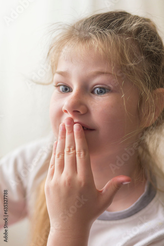 portrait of a beautiful emotional blonde girl in her room