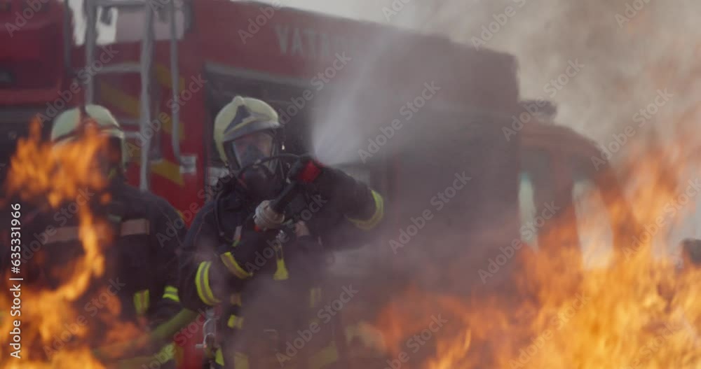 Firefighters using water fire extinguisher to fighting with the fire flame in car accident. Firefighter industrial and public safety concept rescue in night. 