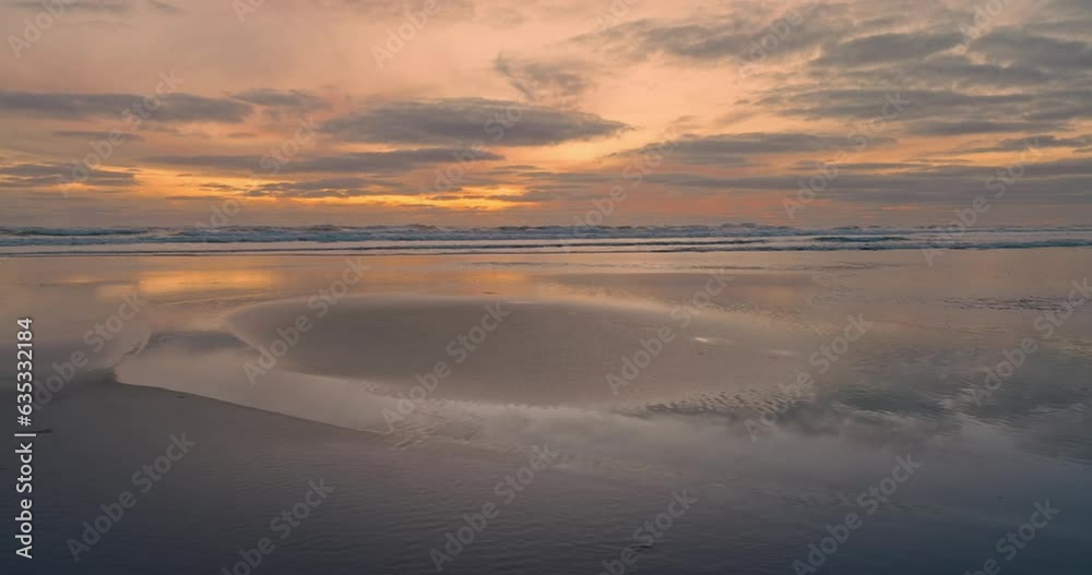Aerial: Calm ocean waves crashing in the surf. Auckland, New Zealand