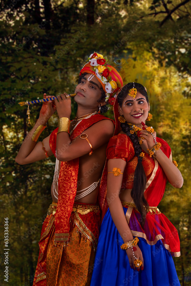 Young man and woman dressed up as Radha and Krishna and romancing on the occasion of Janmashtami Young man and woman dressed up as Radha and Krishna and romancing on the occasion of Janmashtami